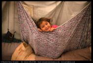 Mani, a young Innu girl plays in a tent at her family’s autumn hunting camp in Labrador, Canada. Bryan and Cherry Alexander Photography.