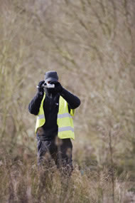 A police officer records a protest against illegal plans to clear vegetation at Radley Lakes Photograph: Adrian Arbib