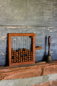 Chalkboard with abacus bell in a one room schoolhouse, courtesy: istock 