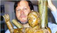 Dana Gioia with a Mexican folk statue of Saint Sebastian