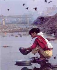 Washing pots in polluted water. 