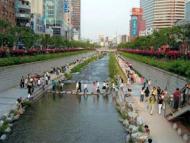 After: residents relaxing on the banks of the Cheonggyecheon river after urban rehabilitation Photog