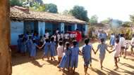 Children playing in front of the school RCC, Chhuinara. Photograph: Ryan Haines